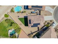 An aerial view of a backyard including a pool, desert landscaping, and solar panels at 41734 N Cielito Linda Way, San Tan Valley, AZ 85140