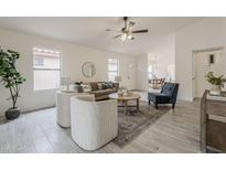 Bright living room featuring neutral furniture, stylish rug, and seamless flow to the dining area at 4545 N 67Th Ave # 1106, Phoenix, AZ 85033