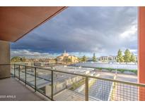 Cityscape view from balcony with wrought iron railing, capturing cityscape and dramatic sky at 4750 N Central Ave # 3B, Phoenix, AZ 85012