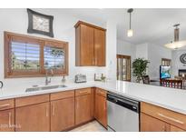 Charming kitchen with quartz countertops, wood cabinets, stainless dishwasher, and natural light at 5350 E Deer Valley Dr # 1419, Phoenix, AZ 85054