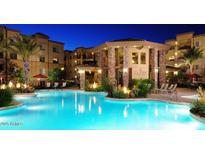 Resort-style pool with lush landscaping, fire bowls, and comfortable lounge chairs under palm trees at 5350 E Deer Valley Dr # 1419, Phoenix, AZ 85054