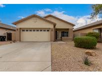 Charming single-level home with a two-car garage and desert landscaping at 606 S 124Th Ave, Avondale, AZ 85323