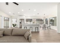 Open floor plan featuring a kitchen island with barstool seating and stainless steel appliances at 7056 W Caron Dr, Peoria, AZ 85345