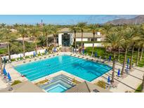Stunning community pool area with palm trees, lounge chairs, and a spacious pool, creating a resort-like atmosphere at 9475 N 115Th Pl, Scottsdale, AZ 85259