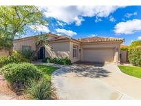 Charming single-story home featuring a tile roof, desert landscaping, and attached two car garage at 9475 N 115Th Pl, Scottsdale, AZ 85259