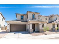 Charming two-story home featuring a covered entryway, neutral stucco, and a two-car garage at 1193 E Spruce Dr, Chandler, AZ 85286