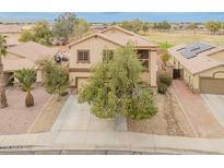 Charming two-story home with a well-manicured front yard and a tile roof at 14450 N 132Nd Dr, Surprise, AZ 85379