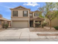 Charming two-story home with a well-manicured front yard and a two-car garage, offering curb appeal at 16157 W Moreland St, Goodyear, AZ 85338