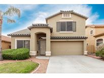 Inviting two-story home with desert landscaping, tile roof, and a spacious two car garage at 16543 W Ironwood St, Surprise, AZ 85388