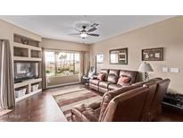 Comfortable living room with a leather sofa, ceiling fan and great natural light at 16616 E Gunsight Dr # 214, Fountain Hills, AZ 85268