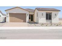 Charming single-story home featuring a neutral color scheme, a two-car garage, and low maintenance landscaping at 1910 E Empeltre Rd, San Tan Valley, AZ 85140