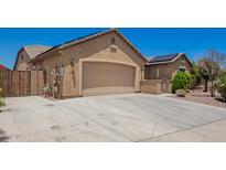 A beige-colored, two-car garage with a concrete driveway and stucco exterior features at 19740 W Sherman St, Buckeye, AZ 85326