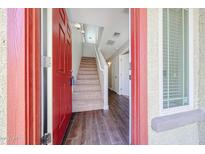 Inviting entryway with wood-look tile flooring and a staircase leading to the upper level at 2150 W Alameda Rd # 1122, Phoenix, AZ 85085