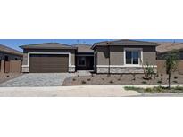 Charming single-story home with a two-car garage, stone accents, and a well-maintained front yard at 24116 N 172Nd Ave, Surprise, AZ 85387