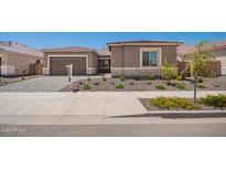 Charming single-story home features a two-car garage and landscaped front yard at 24116 N 172Nd Ave, Surprise, AZ 85387