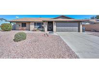 Charming single-story brick home with a well-manicured desert landscape and inviting curb appeal at 3004 W Anderson Dr, Phoenix, AZ 85053