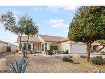 Charming single-story home featuring desert landscaping and a welcoming front patio with seating area at 3089 E Hazeltine Way, Chandler, AZ 85249