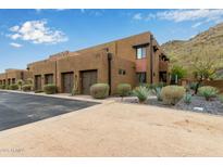 Contemporary two-story townhome featuring an attached two-car garage and desert landscaping, close to local mountain at 36600 N Cave Creek Rd # C17, Cave Creek, AZ 85331