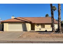 Charming single-story home with a tile roof, a two-car garage and a desert style front yard at 4330 E Beck Ln, Phoenix, AZ 85032