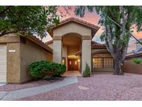 Charming home featuring a tiled roof, manicured landscaping, and double door entry with inviting curb appeal at 438 E Vaughn Ave, Gilbert, AZ 85234