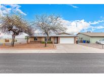 Charming single-story home featuring a two-car garage, brick accents, and a well-maintained front yard at 5401 S Siesta Ln, Tempe, AZ 85283