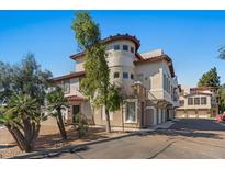 Stucco two-story home featuring a red tile roof, a charming turret, and mature landscaping at 7420 E Northland Dr # B101, Scottsdale, AZ 85251