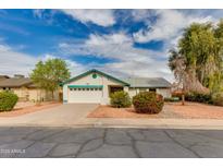 Charming single-story home features a well-manicured front yard and attached two-car garage at 962 E Greenway St, Mesa, AZ 85203