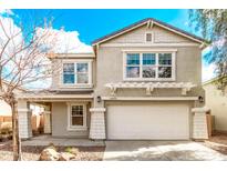 Charming two-story home with a well-maintained front yard and a two-car garage at 16425 N 172Nd Ln, Surprise, AZ 85388