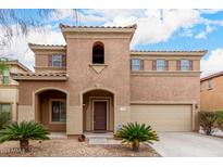 Charming two-story home featuring a unique architectural style with a tiled roof and a well-maintained front yard at 17358 N 185Th Ln, Surprise, AZ 85374