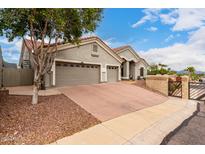Exterior showcases a 2-car garage, driveway, stucco walls, and tile roof on a sunny day at 1954 E Vista Dr, Phoenix, AZ 85022