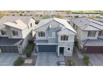 A modern two-story home with a stone facade, well-manicured landscaping, and a two-car garage at 2855 E Tina Dr, Phoenix, AZ 85050
