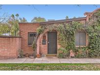 Quaint brick home featuring a vine-covered arched entryway and a landscaped yard at 3002 N 32Nd St # 13, Phoenix, AZ 85018