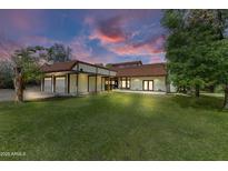 Spacious single-Gathering home boasts a large front yard, a two-car garage, and a charming tile roof at 3264 E Vineyard Rd, Phoenix, AZ 85042