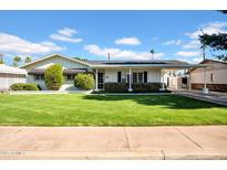 Charming single-story home with well-maintained lawn, quaint carport, and inviting curb appeal at 3338 E Turney Ave, Phoenix, AZ 85018