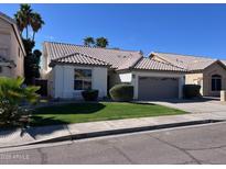 Charming single-story home featuring a well-manicured lawn and a lovely tiled roof at 4751 E White Aster St, Phoenix, AZ 85044