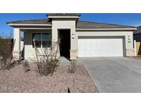 Charming single-story home featuring a two-car garage, neutral stucco, and low-maintenance desert landscaping at 4919 S 106Th Ave, Tolleson, AZ 85353