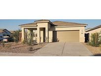 Inviting single-story home with a neutral palette, low-maintenance landscaping, and an attached two-car garage at 4919 S 106Th Ave, Tolleson, AZ 85353