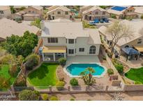 A beautiful backyard boasts a pool, lush greenery, and charming landscaping at 5332 W Linda Ln, Chandler, AZ 85226