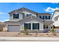 Charming two-story home with gray stucco, dark shutters, a two-car garage and low maintenance landscaping at 5710 N 84Th Ave, Glendale, AZ 85305