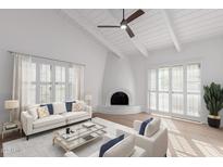 Bright living room featuring vaulted ceilings, fireplace, and light-colored furniture and decor at 6349 N 78Th St # 123, Scottsdale, AZ 85250
