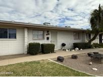 Charming single-story home with white brick exterior, manicured landscaping, and a welcoming front entrance at 7129 W Meadowbrook Ave, Phoenix, AZ 85033