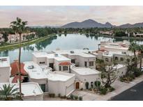 Beautiful waterfront home featuring desert landscaping and a view of Camelback mountain at 8369 E Del Camino Dr, Scottsdale, AZ 85258