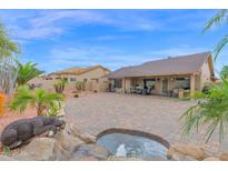 Expansive backyard featuring a water feature, mature landscaping, and ample space for outdoor living and entertaining at 9740 W Rockwood Dr, Peoria, AZ 85382