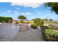 Relaxing outdoor patio featuring beautiful landscaping and golf course view at 15560 W Clear Canyon Dr, Surprise, AZ 85374
