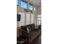 Cozy living room with a comfortable brown couch, modern decor, and plenty of natural light at 2058 S Walla Walla Cir, Apache Junction, AZ 85119