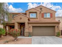 Inviting two-story home boasting a tile roof, two-car garage, and a beautifully landscaped front yard at 24805 W Vista Norte St, Buckeye, AZ 85326