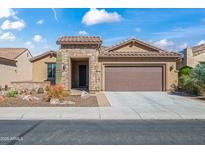 Charming single-story home with a well-manicured front yard and attached two-car garage at 26336 W Tina Ln, Buckeye, AZ 85396