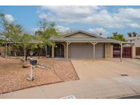Charming single-story home featuring a covered carport, well-maintained landscaping, and a welcoming brick pathway at 3224 W Ironwood Dr, Phoenix, AZ 85051