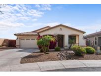 Charming single-story home features a two-car garage and desert landscaping at 3253 N 138Th Ave, Avondale, AZ 85392