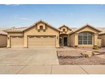 Charming single-story home featuring a three car garage and a well-manicured xeriscaped front yard at 3348 E Sequoia Dr, Phoenix, AZ 85050